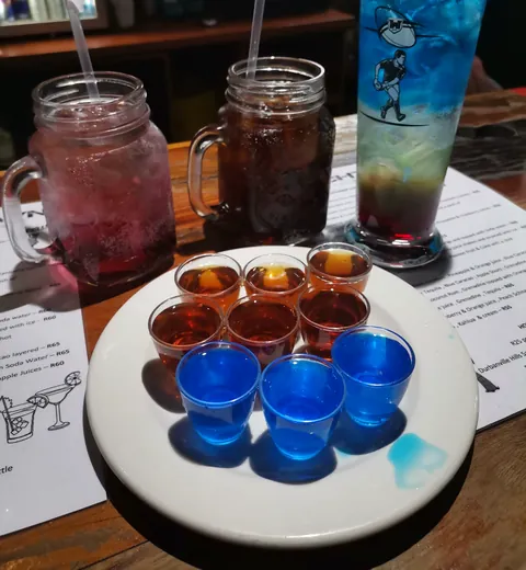 A tray of shooters and jam-jar cocktails on a Trenchtown table